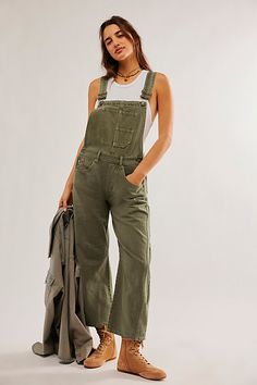 Our top-rated Good Luck Barrel Jeans — now in a timeless overall silhouette! Featuring the signature barrel-leg fit, you’ll be reaching for this pair all season long. **Fit:** Bib-and-brace design with wide barrel-leg **Features:** Front bib pocket, tapered knee design, adjustable brace straps, side button detailing **Why We ❤ It:** Toughened-up with moto boots or laid-back with sporty sneakers, this pair has endless ways to wear. | We The Free Good Luck Barrel Overalls at Free People in Green, Size: XS Green Overalls, Town Outfits, Weeping Willow, Sporty Sneakers, Lucky You, Jumpsuit Fashion, Denim Overalls, Look At You, Moto Boots