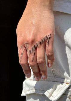 a woman's hand with writing on it and the word running written in cursive ink