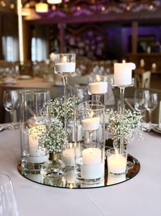 a table topped with lots of candles and flowers