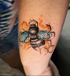 a tattoo on the arm of a person with a bee