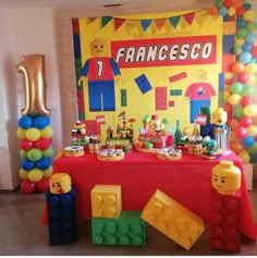 a table topped with legos and balloons in front of a sign that says francesco