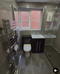 a bathroom with a toilet, sink and shower stall