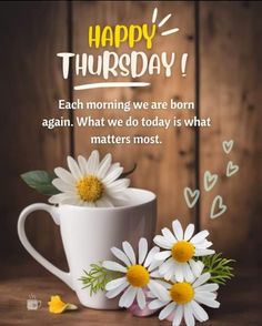 a coffee cup with daisies in it and the words happy thursday