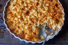 a casserole dish with a spoon in it on a baking pan, ready to be eaten