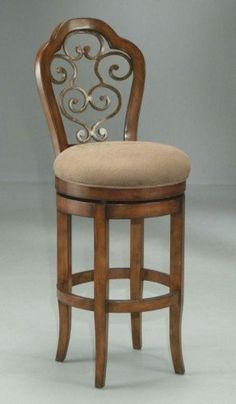 a wooden bar stool with a beige upholstered seat and back cushion on an isolated grey background