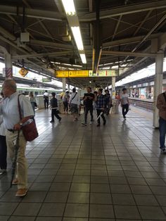 many people are walking around in the train station