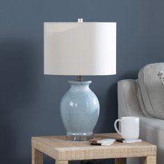 a table with a lamp on it next to a couch