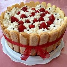 a cake with strawberries and whipped cream on top