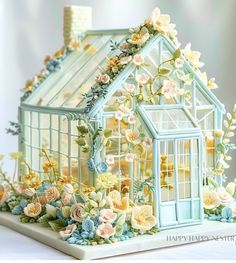 there is a miniature house made out of flowers