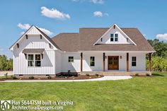 a white house sitting on top of a lush green field