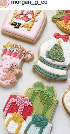 decorated christmas cookies are displayed on a table