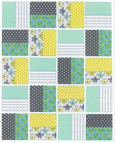 a patchwork quilt with yellow, blue and grey squares on it's sides