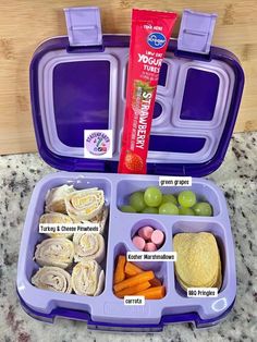 a purple lunch box filled with food on top of a counter