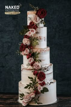 a three tiered cake with red flowers on top