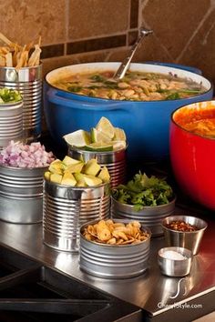 several bowls of food are sitting on the stove top next to each other in tins