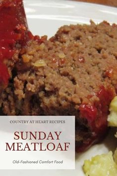 a white plate topped with meatloaf covered in gravy next to potatoes