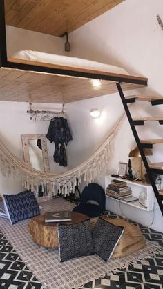 there is a hammock bed in the corner of this living room with stairs