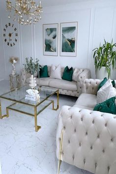 a living room filled with white couches and green pillows