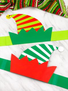 the paper hats are on top of each other and one is red, green, yellow and white