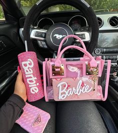 a pink purse sitting on top of a car steering wheel