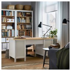 a living room filled with furniture and a book shelf next to a window covered in books