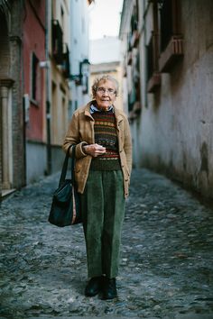 an older woman standing in the middle of a narrow alleyway with text reading connie tuori travel for life