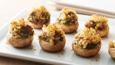 small stuffed mushrooms with toppings on a white plate