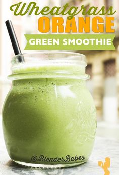 a green smoothie in a mason jar with a straw on top and the words, wheatgrass orange green smoothie