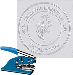 a stamper with a flower on it next to a piece of paper that reads from the library of nicole young