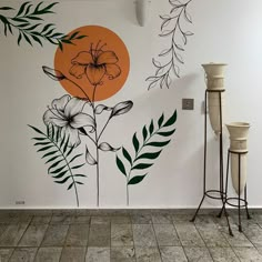 a wall with flowers and leaves painted on it