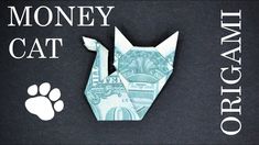 an origami cat made out of money on top of a black background with the words money cat written below it