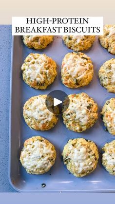 a baking pan filled with biscuits covered in cheese