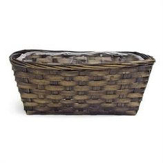 a brown basket sitting on top of a white surface