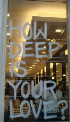 the words how deep is your love written in a window