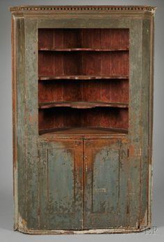 an old wooden cabinet with two doors and shelves