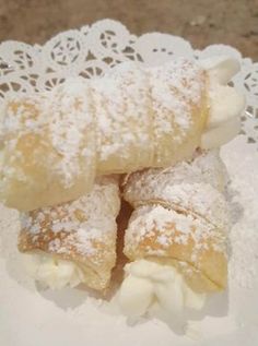 powdered sugar covered pastries on a white plate