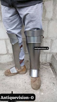 the legs and ankles of a person wearing metal armor