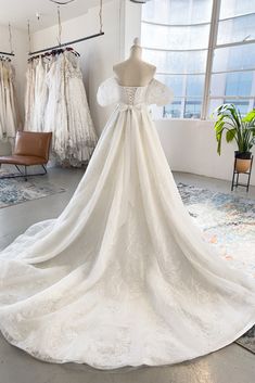 a wedding dress on display in a bridal shop