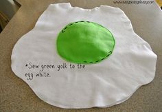 an egg is on top of a piece of paper with the words sew green yolk to the egg white