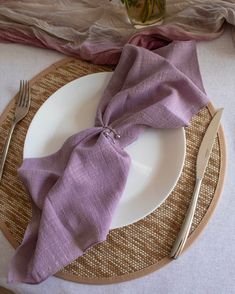 a plate with a purple napkin on top of it