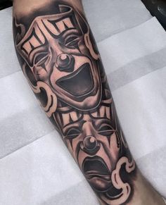 a black and grey tattoo on the leg of a person with an evil clown mask