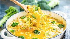 broccoli and chicken casserole in a white pot with a wooden spoon