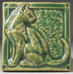 a ceramic tile with a cat on it