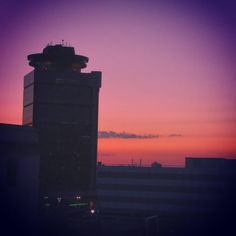 an airplane is flying in the sky at sunset