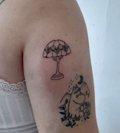 a woman's arm with a tattoo on it that has an umbrella in the middle