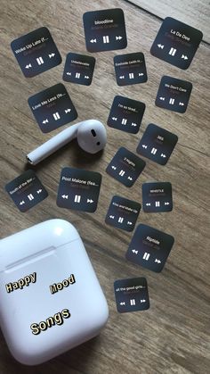 an apple airpods sitting on top of a wooden table next to some mp3 players