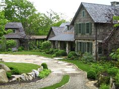 a stone driveway leading to a large house