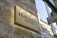 a sign on the side of a building that says hachett london in gold