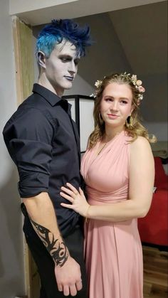 a man and woman are dressed up as male and female characters, with blue hair