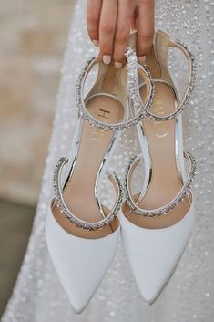 the bride's white shoes are adorned with crystal stones